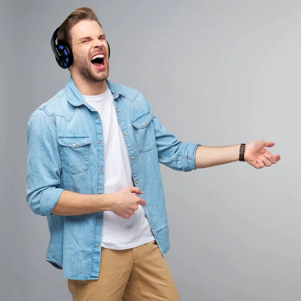 Close up retrato de jovem alegre gostando de ouvir música vestindo roupas de jeans casuais — Fotografia de Stock