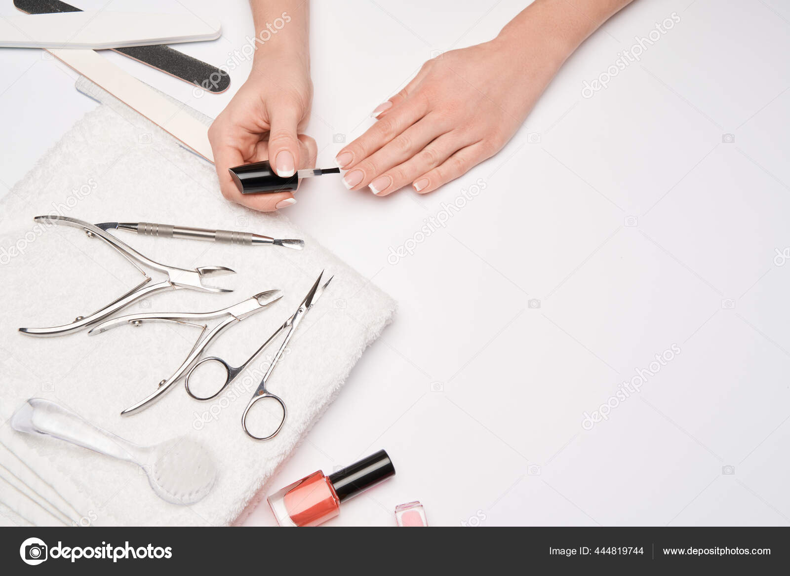 Top view of manicure tools set for nail care over light background - brush,  scissors, nail polish, file and tweezers Stock Photo by ©repinanatoly  444819744