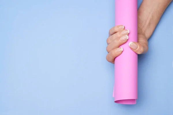 Mãos femininas bonitas com manicure francês sobre fundo de papel colorido — Fotografia de Stock