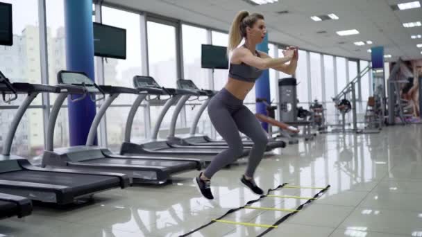 Ung kvinna cardio träning hoppa på gym gym gym — Stockvideo