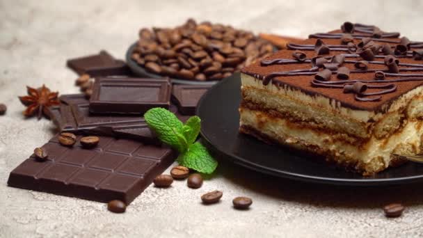 Portie traditioneel Italiaans Tiramisu dessert en stukjes chocoladereep — Stockvideo