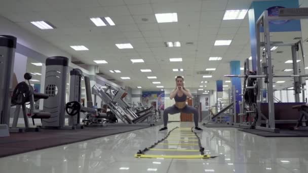 Young woman cardio exercising jumping at gym fitness center — Stock Video