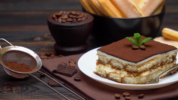 Portion of Traditional Italian Tiramisu dessert, coffee beans and savoiardi cookies — Stock Video