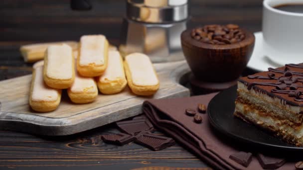 Portion of Traditional Italian Tiramisu dessert, cup of espresso, mocha and coffee beans — Stock Video