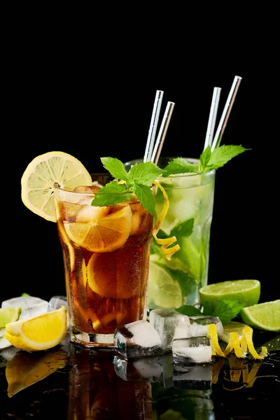 Glass of Fresh Long Island Ice Tea and Mojito Cocktail - studio shot on black background — Stock Photo, Image