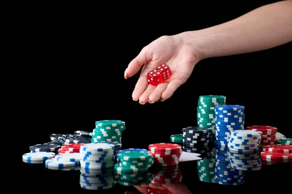 Casino chips, playing cards and dices on dark reflective background — Stock Photo, Image