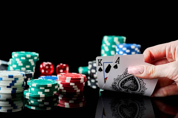 Casino chips, playing cards and dices on dark reflective background — Stock Photo, Image