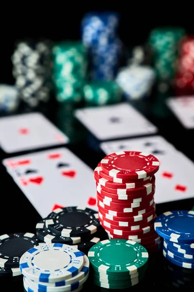 Casino chips, playing cards and dices on dark reflective background — Stock Photo, Image