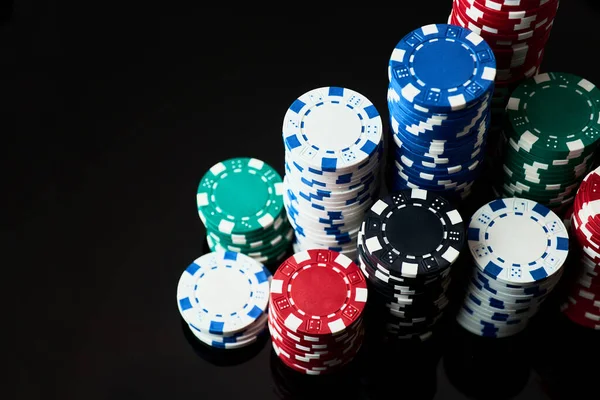 Pila di Casino gioco d'azzardo chip isolato su sfondo nero riflettente — Foto Stock