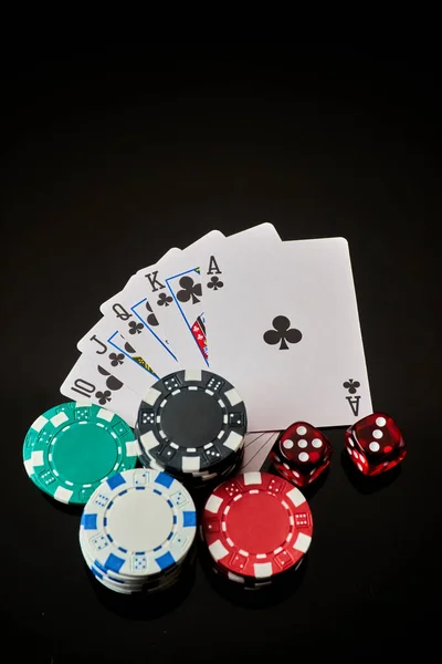 Casino chips, playing cards and dices on dark reflective background — Stock Photo, Image