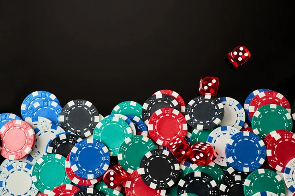 Frame made of Casino chips and dices on dark reflective background with copy space — Stock Photo, Image