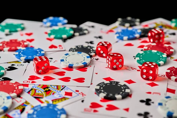 Casino chips, playing cards and dices on dark reflective background — Stock Photo, Image