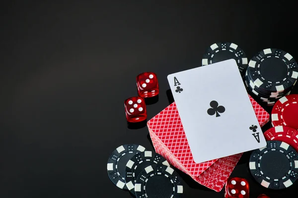 Casino chips, playing cards and dices on dark reflective background — Stock Photo, Image