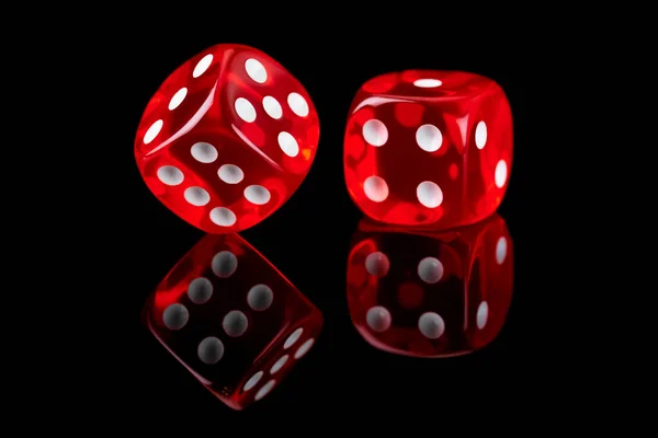 Red casino dice isolated over black reflective background — Stock Photo, Image