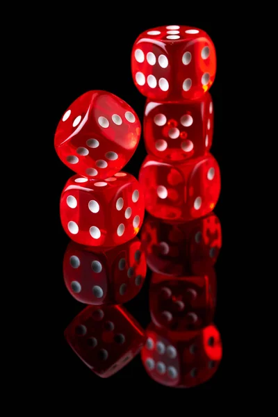 Red casino dice isolated over black reflective background — Stock Photo, Image