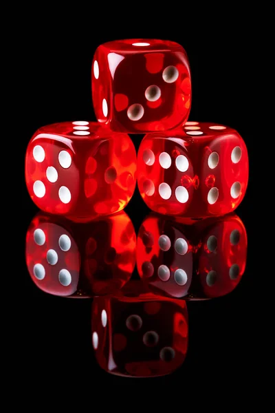 Red casino dice isolated over black reflective background — Stock Photo, Image