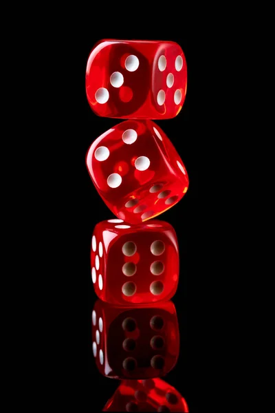 Red casino dice isolated over black reflective background — Stock Photo, Image