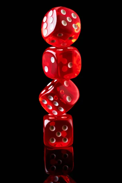 Red casino dice isolated over black reflective background — Stock Photo, Image