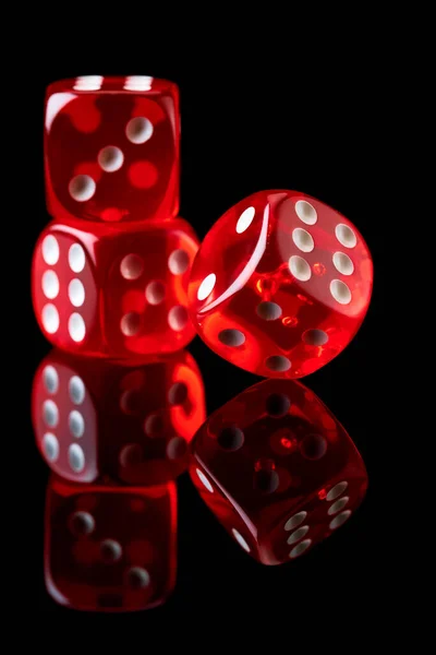 Red casino dice isolated over black reflective background — Stock Photo, Image