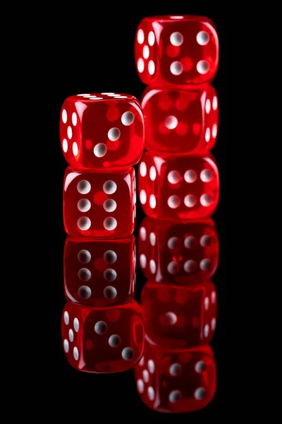 Red casino dice isolated over black reflective background — Stock Photo, Image