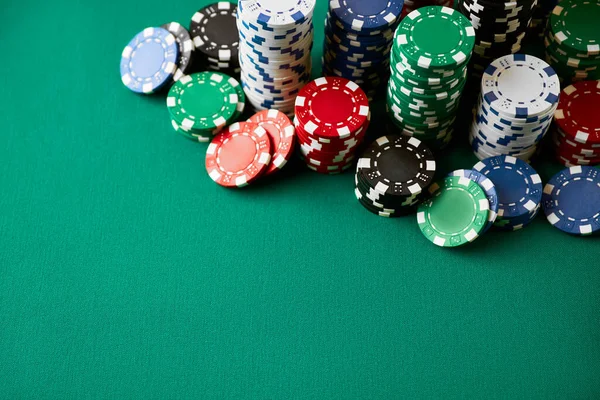 Stack of Casino gambling chips on green table — Stock Photo, Image