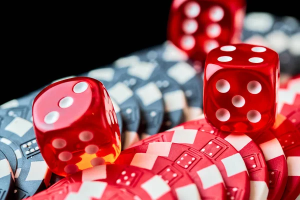 Red casino dice and chips isolated over black reflective background — Stock Photo, Image