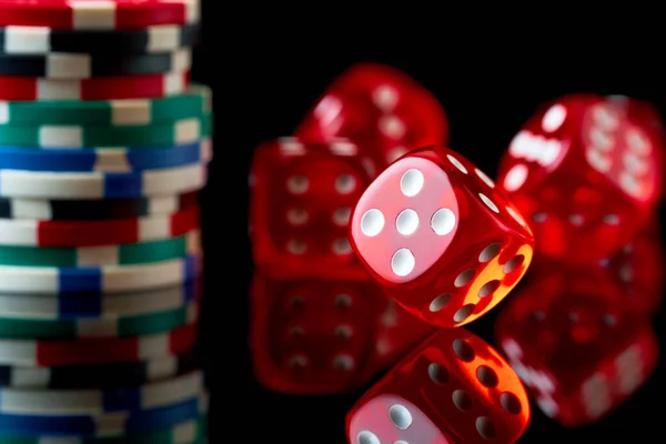 Red casino dice and chips isolated over black reflective background — Stock Photo, Image