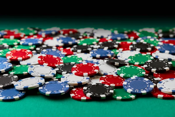 Pile of Casino pocker gambling chips on green table — Stockfoto