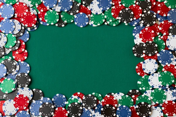 Pile of Casino pocker gambling chips on green table — Stock Photo, Image