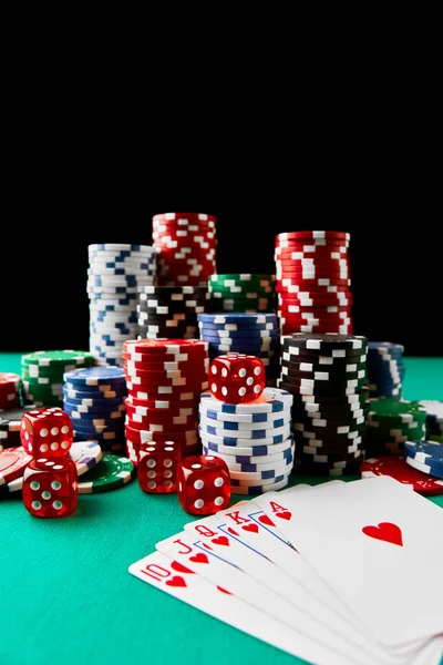 Casino chips, playing cards and dices on green fabric table — Stock Photo, Image
