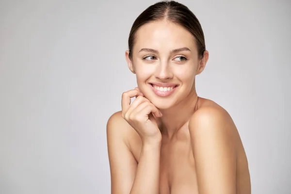 Beautiful Young Woman with Clean Fresh Skin standing over light grey background — Stock Photo, Image