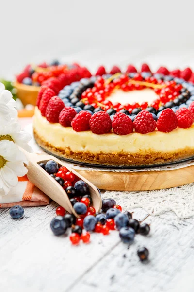 Tarta de queso con frambuesa y arándanos sobre mesa de madera —  Fotos de Stock