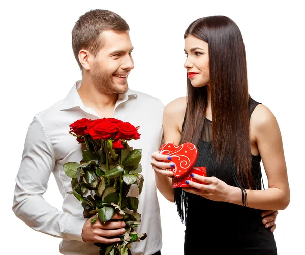 Young beautiful couple with present isolated on white — Stock Photo, Image