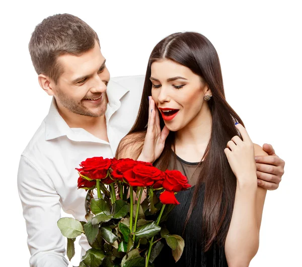 Young beautiful couple with flowers isolated on white — Stock Photo, Image