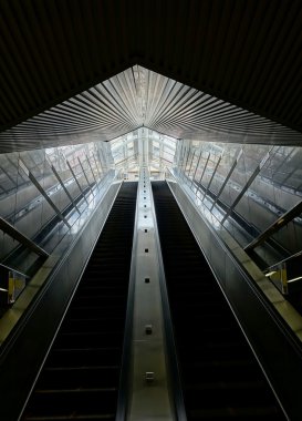 Long Escalators Lead out of an Underground Passage clipart