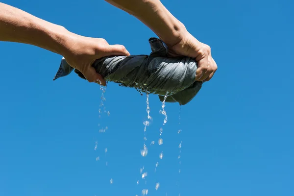 Hand squeezing cloth. — Stock Photo, Image