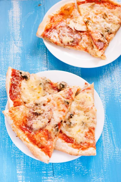 Pizza on wooden table — Stock Photo, Image