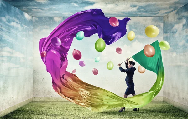 Woman waving colorful flag — Stock Photo, Image