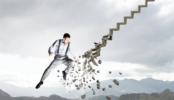 Man breaking ladder — Stock Photo, Image