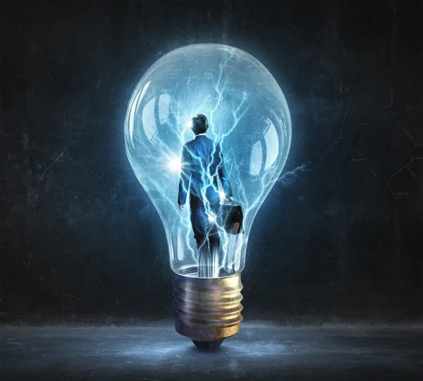 Homem dentro da lâmpada elétrica — Fotografia de Stock