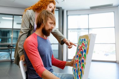 Young caucasian couple standing in a gallery and contemplating artwork clipart