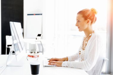 Çekici ofis çalışanı masada oturuyor.