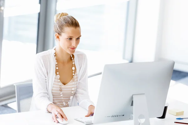 Attractive office worker sitting at desk — Stock Photo, Image