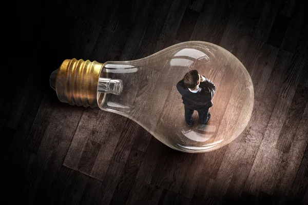 Man inside of electric bulb — Stock Photo, Image