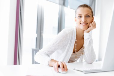 Çekici ofis çalışanı masada oturuyor.