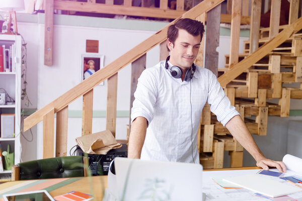 Young man standing in creative office
