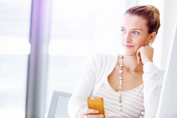 Attractive office worker sitting at desk — Stock Photo, Image