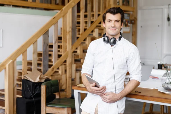 Young man standing in creative office — Stock Photo, Image