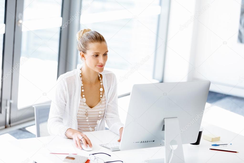 Attractive office worker sitting at desk