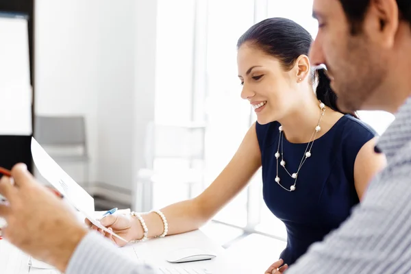 Attractive office worker sitting at desk — Stock Photo, Image